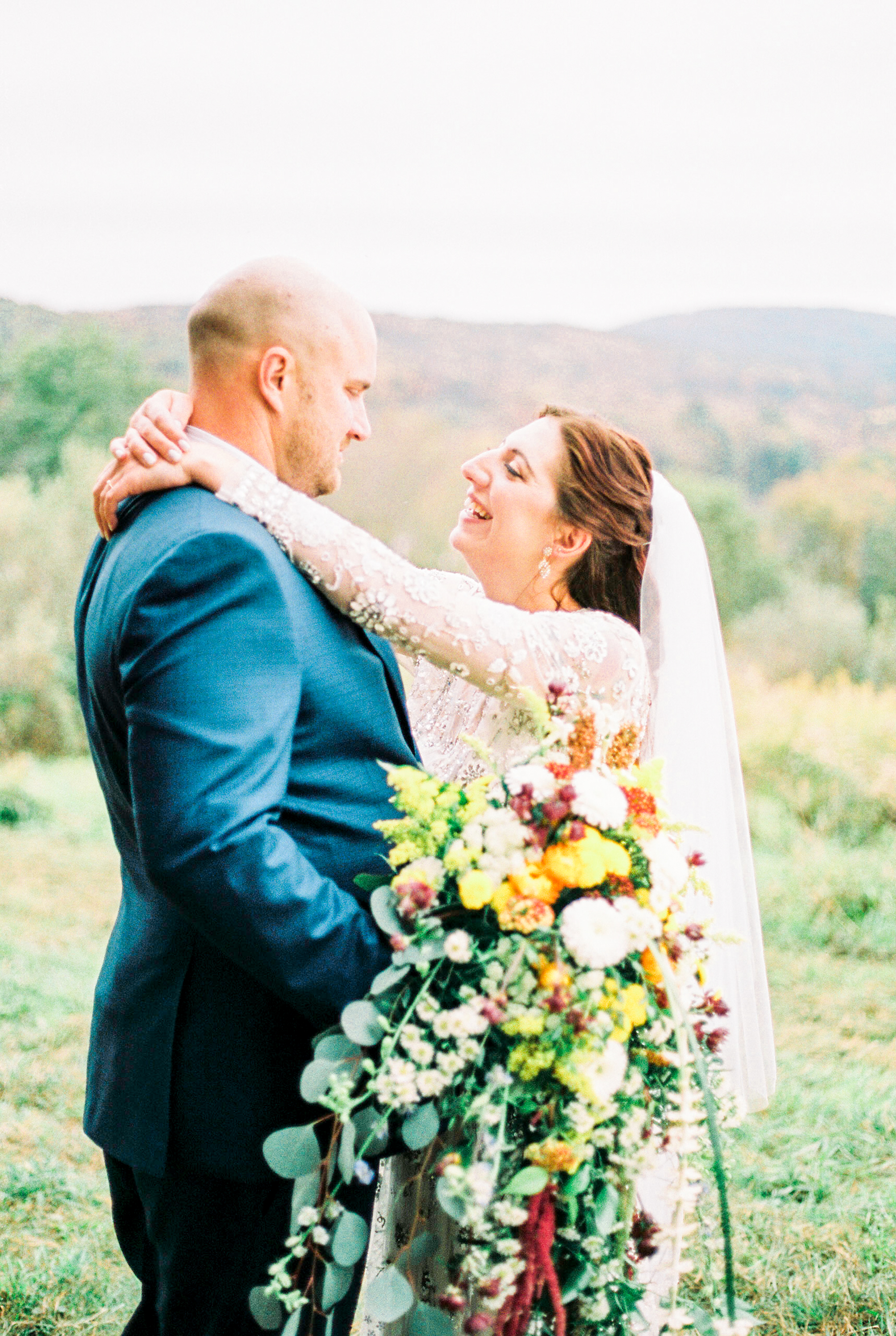 Genuine candid moment shared between the wedding couple during the first look, photographed by New Jersey fine art hybrid photographer, Michelle Behre Photography, private estate fall wedding in at Lake Louise, Dallas, Pennsylvania.