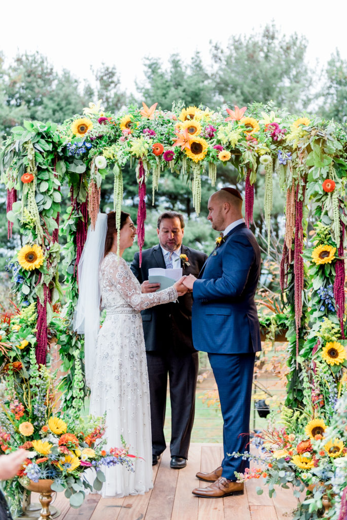 exchanging of vows, photographed by New Jersey fine art hybrid photographer, Michelle Behre Photography, private estate fall wedding in at Lake Louise, Dallas, Pennsylvania.