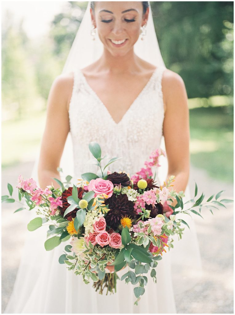 Beautiful bridal portraits and bridal bouquet of pink roses and maroon dahlias by Crossed Keys Designs at the Crossed Keys Estate by New Jersey Wedding Photographer, Michelle Behre Photography.