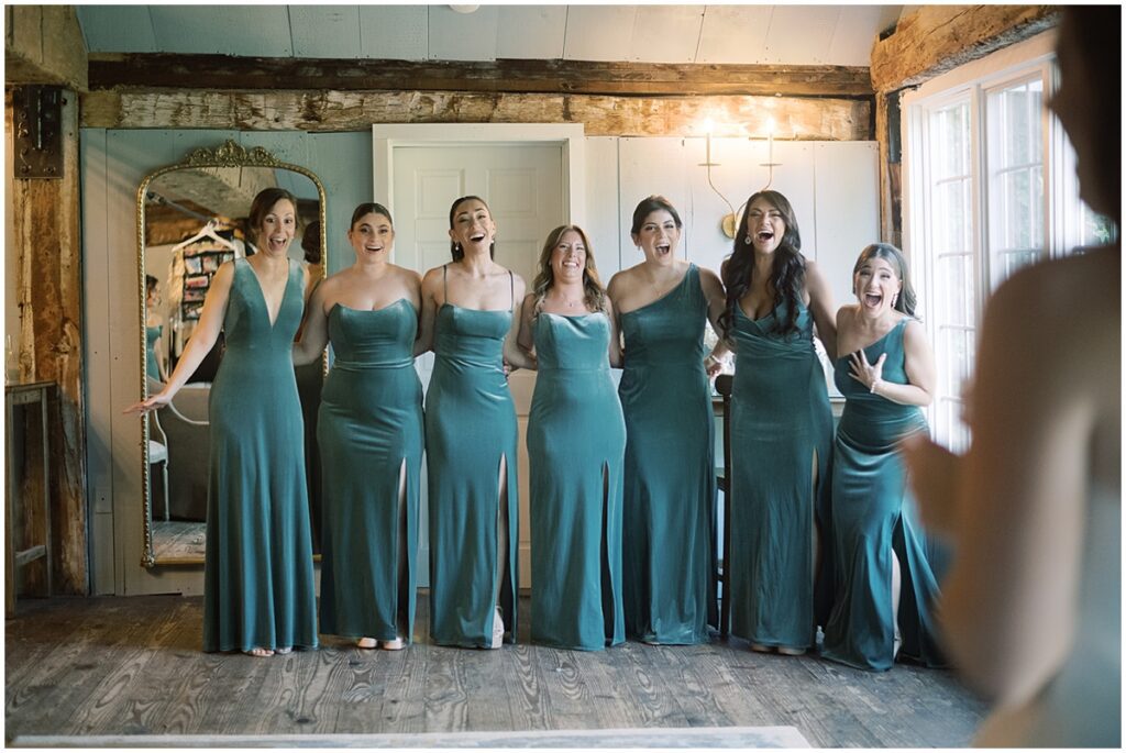 a reveal with the bridal party captured by nj wedding photographers michelle behre at the crossed keys estate